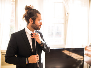 young man with long hair wearing a suit - Powered by Adobe