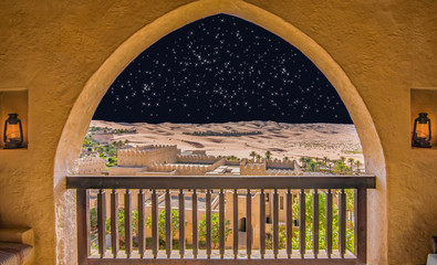 Arabic architecture. Balcony overlooking the desert and a night sky full of stars.