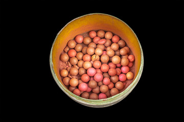 colored balls cosmetic powder on a black background close-up