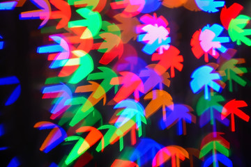 Blurred view of beautiful lights on dark background