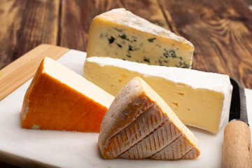 Tasting plate with four France cheeses, cream brie, marcaire, saint paulin and blue auvergne...