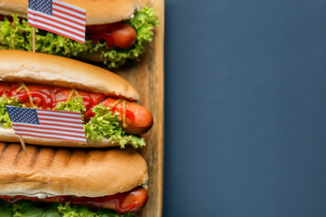 Tasty hot dogs with American flags on board