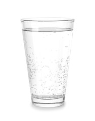 Glass of cold mineral water on white background