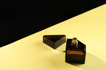 Bottle of perfume on color background