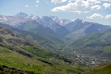 Naklejka premium Rocky snow-capped mountains over the village of Fiagdon in North Ossetia.