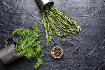 Fresh aromatic dill with rosemary and spices on dark background