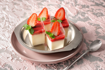 Glasses with tasty strawberry panna cotta on metal tray