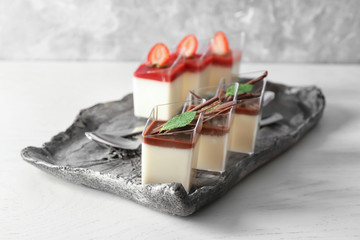 Glasses with tasty panna cotta on plate