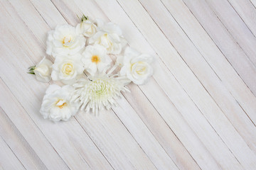Fototapeta na wymiar White Flowers on White Wood Table