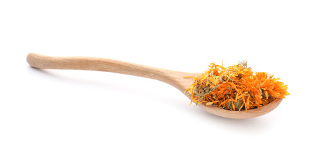 Wooden spoon with dried calendula flowers on white background