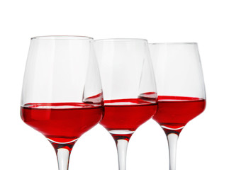 Glasses with sweet tasty wine on white background