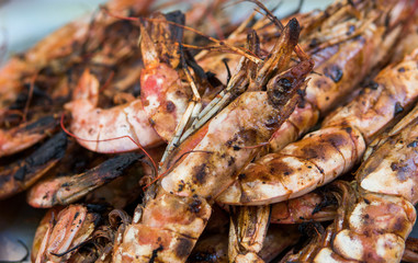 Appetizing grilled royal shrimp. Seafood grill on the stove, on the street food market.