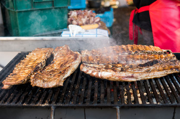 Cooking pork ribs on a grill. Meat on a grills.