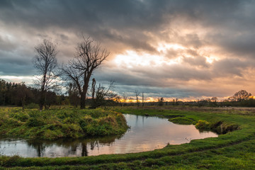 Fototapeta premium Landscape with Jeziorka river at clody day near Piaseczno, Masovia, Poland