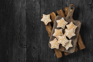 Cookies in the form of stars on the black wooden table
