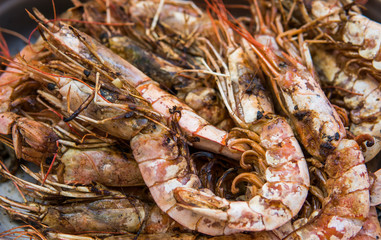 Appetizing grilled royal shrimp. Seafood grill on the stove, on the street food market.