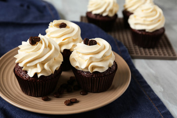 Tasty chocolate cupcakes on plate