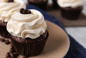 Tasty chocolate cupcake on plate, closeup