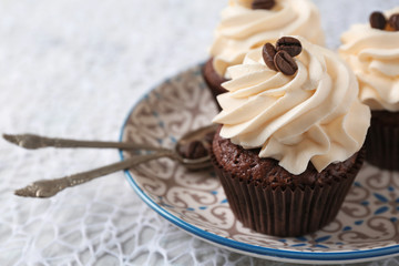 Tasty chocolate cupcakes on plate, closeup