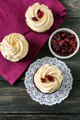 Tasty chocolate cupcakes on wooden table