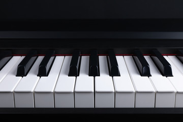 Grand piano keyboard with glossy black and white keys as a music, Select focus and soft focus.