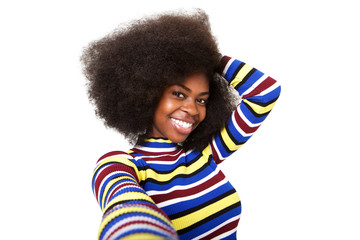 Close up smiling young black woman taking selfie against isolated white background