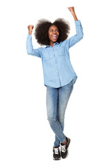 Full length happy young woman cheering with hands raised