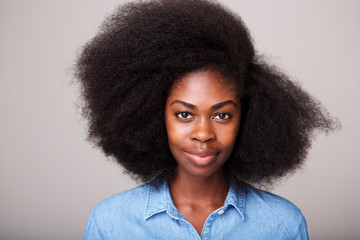 Close up portrait of beautiful young black woman with afro hair staring