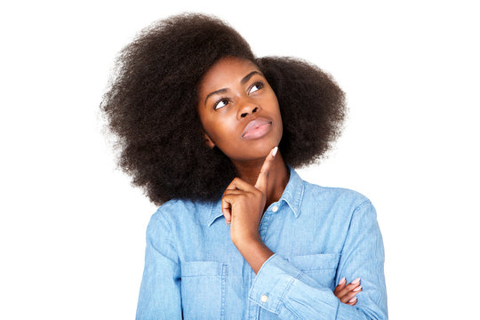Close up thinking young black woman with afro looking up at copy space