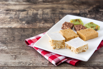 Christmas nougat on wooden table. Copyspace