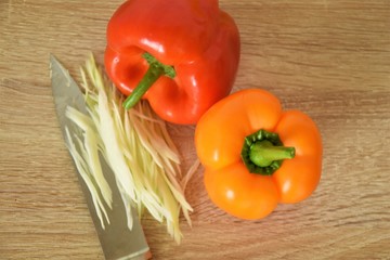 paprika, orange and red whole, and shredded cabbage