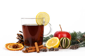 christmas background - christmas tea or mulled wine - cup of red tea and orange - isolated on white...