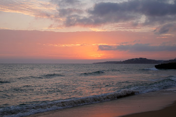 evening sun over the ocean. Skies in the rays of salty light. Bright orange sunset
