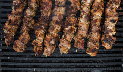 Assorted delicious grilled meat over the coals on barbecue.