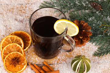 christmas tea or mulled wine on wooden table with snow  - christmas background