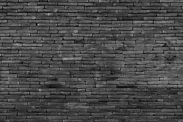 Dark gray brick wall as a background or texture