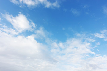 Blue sky background and white clouds soft focus, and copy space