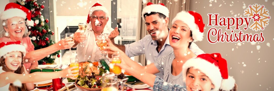 Composite image of family in santas hats toasting wine glasses