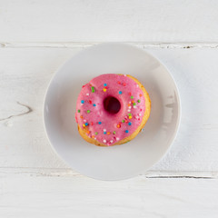 Donut on white background. Close up. Copy space.