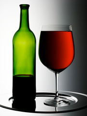 GLASS OF RED WINE WITH BOTTLE