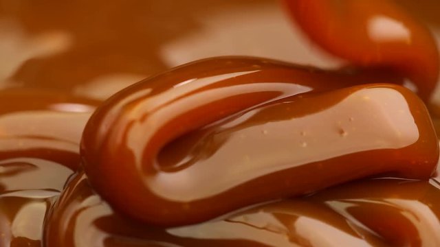  Caramel dripping thick strand. Slow motion.