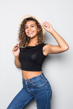 Portrait of a young latino american girl in a casual and straw hat isolated on white background