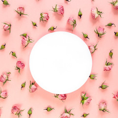 Fototapeta na wymiar Round frame with pink roses on pink background. Place for text.
