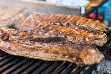 Cooking pork ribs on a grill. Meat on a grills.