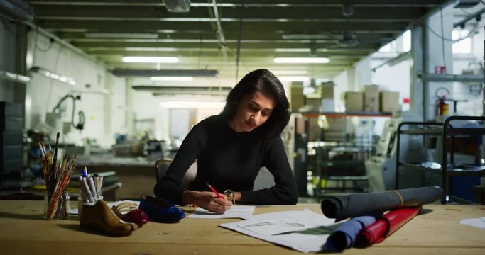Portrait of professional fashion designer drawing a new shoe model according to the italian tradition. Concept:fashion, design, mode, style
