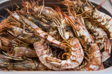 Appetizing grilled royal shrimp. Seafood grill on the stove, on the street food market.