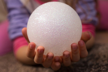 Child Holding Christmas Ball Decoration