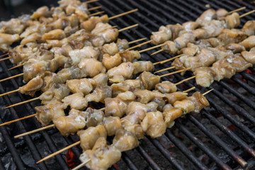 Rapan meat on the grill. Delicious festive barbecue. Food and holiday concept. Cooking BBQ seafood on fire.