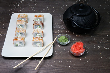 japanese rolls served on plate on dark table