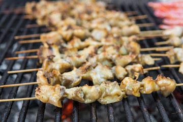 Rapan meat on the grill. Delicious festive barbecue. Food and holiday concept. Cooking BBQ seafood on fire.